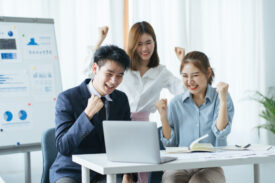 People evaluate positive results of work on charts in office of crypto currency. At ounseling cent