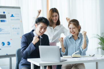 People evaluate positive results of work on charts in office of crypto currency. At ounseling cent