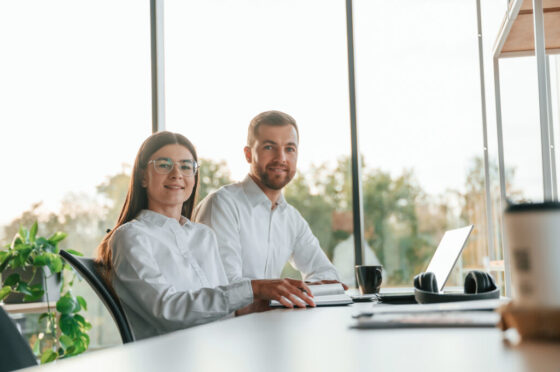 Side view. Man and woman are working in the modern office together